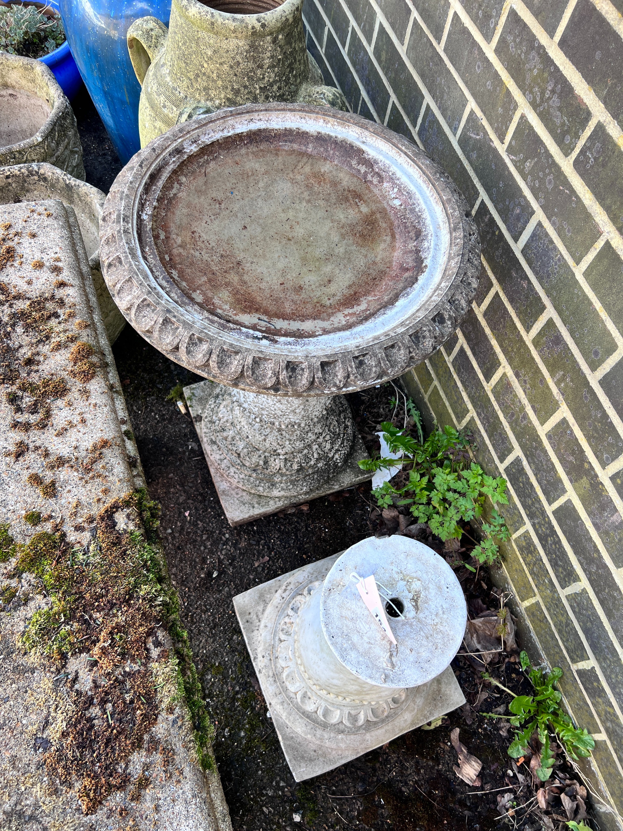 A circular reconstituted stone bird bath, diameter 50cm, height 62cm, together with a faux marble pedestal